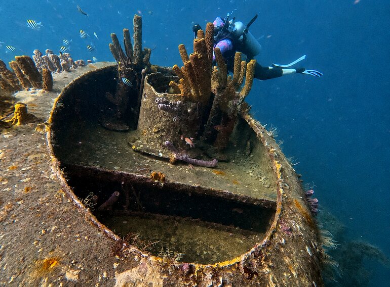 Scuba diver exploring the Atlantic Princess wreck near Bayahibe