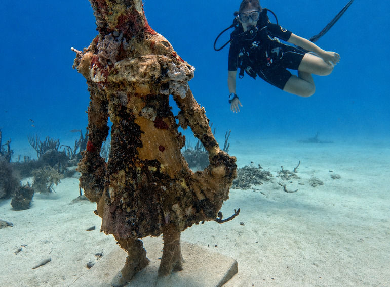 Underwater statue and scuba diver at Coco Reef in Bayahibe