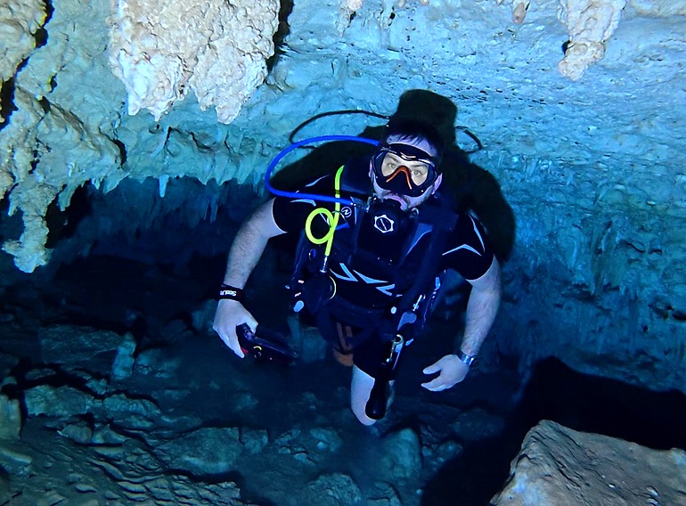 Scuba diver beneath limestone formations at El Chicho cavern in the Dominican Republic