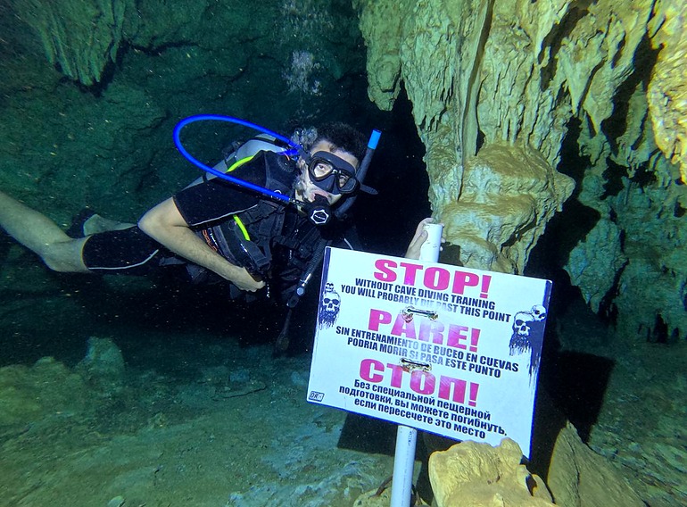 Cave diving warning sign marking the limit for divers without cave training