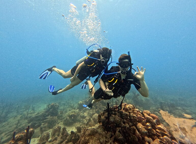 Two first-time divers enjoying Discover Scuba Diving in the Caribbean Sea near Bayahibe
