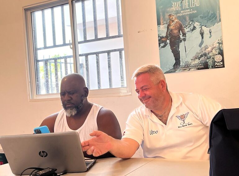 Udo mentoring a Divemaster candidate during professional dive theory and planning at Ultra Marine Divers