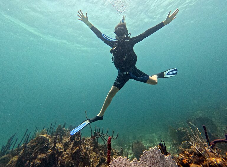 Relaxed scuba diver enjoying a guided Caribbean Sea dive from Punta Cana