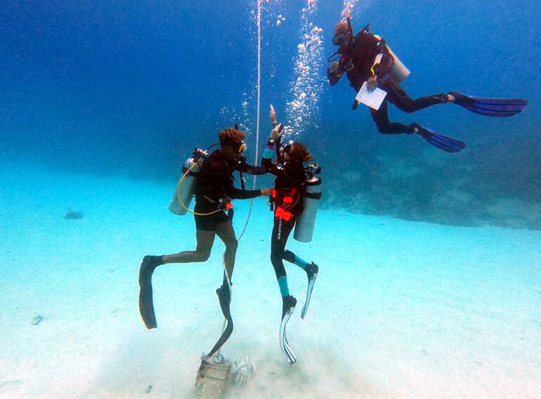 Scuba instructor candidates practising confined-water skill presentations with students