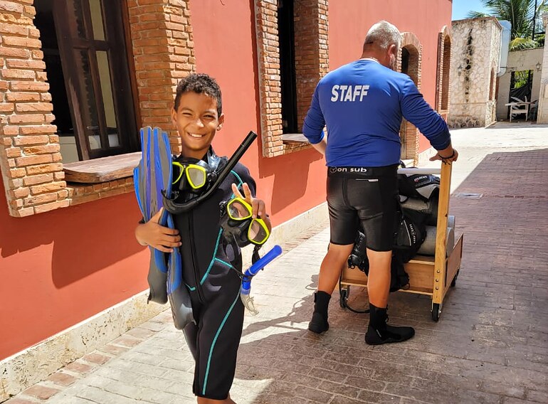 Young Junior Open Water Diver student ready for training with mask, snorkel and fins in Bayahibe