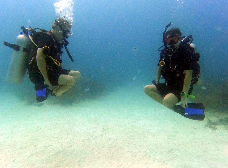 Diver practising horizontal trim and controlled movement during buoyancy training