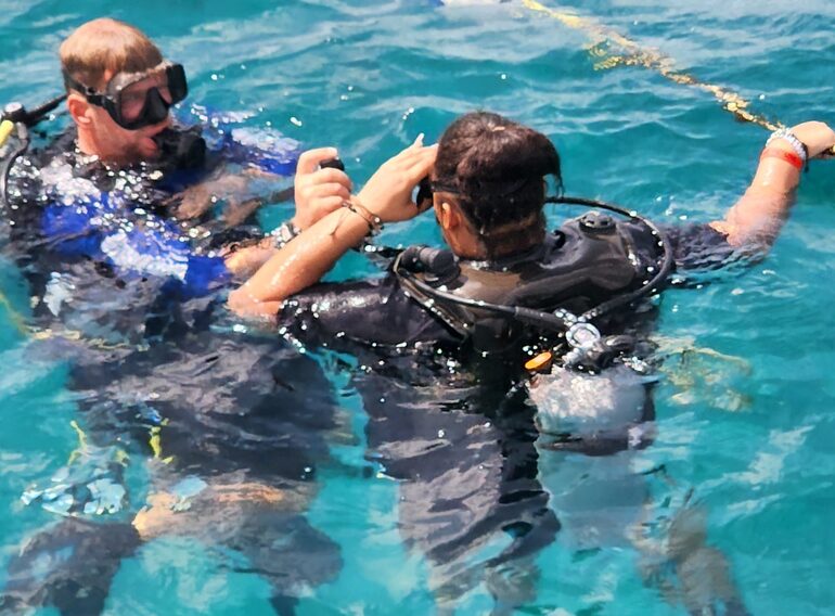 Rescue Diver students practising surface assistance with an instructor in the Caribbean Sea