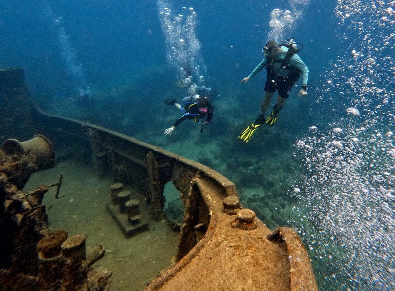 Scuba divers exploring the Atlantic Princess shipwreck on a Saona Island dive trip