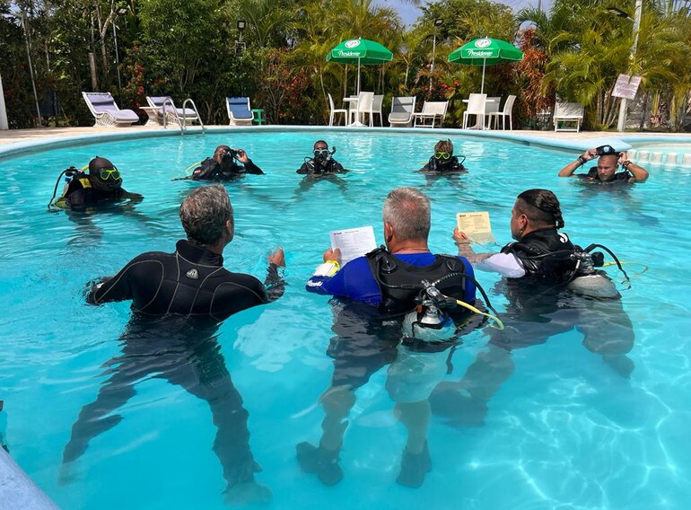 Scuba instructor candidates practising how to teach pool skills