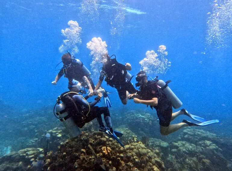 Small group scuba diving on a Caribbean reef near Bayahibe