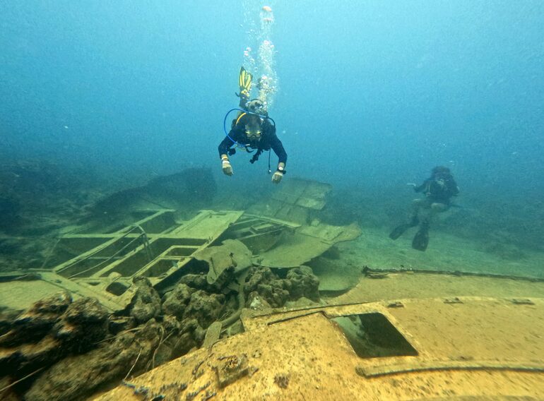 Divers exploring a Caribbean wreck during scuba specialty training from Bayahibe